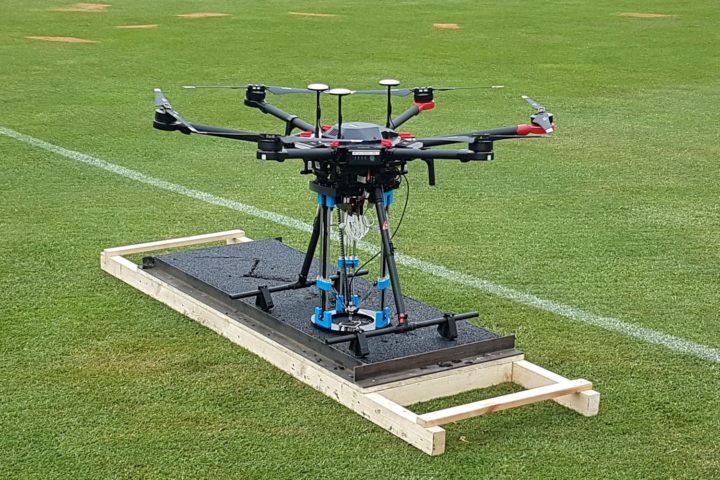 Photo of 3D printing drone on cracked asphalt slab