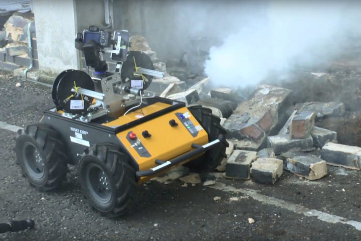 Image of Husky robot navigating round broken rubble