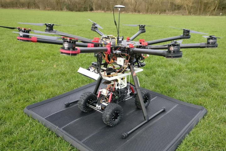 Drone with wheeled robot attached underneath for transportation