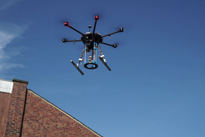 Drone in flight over building